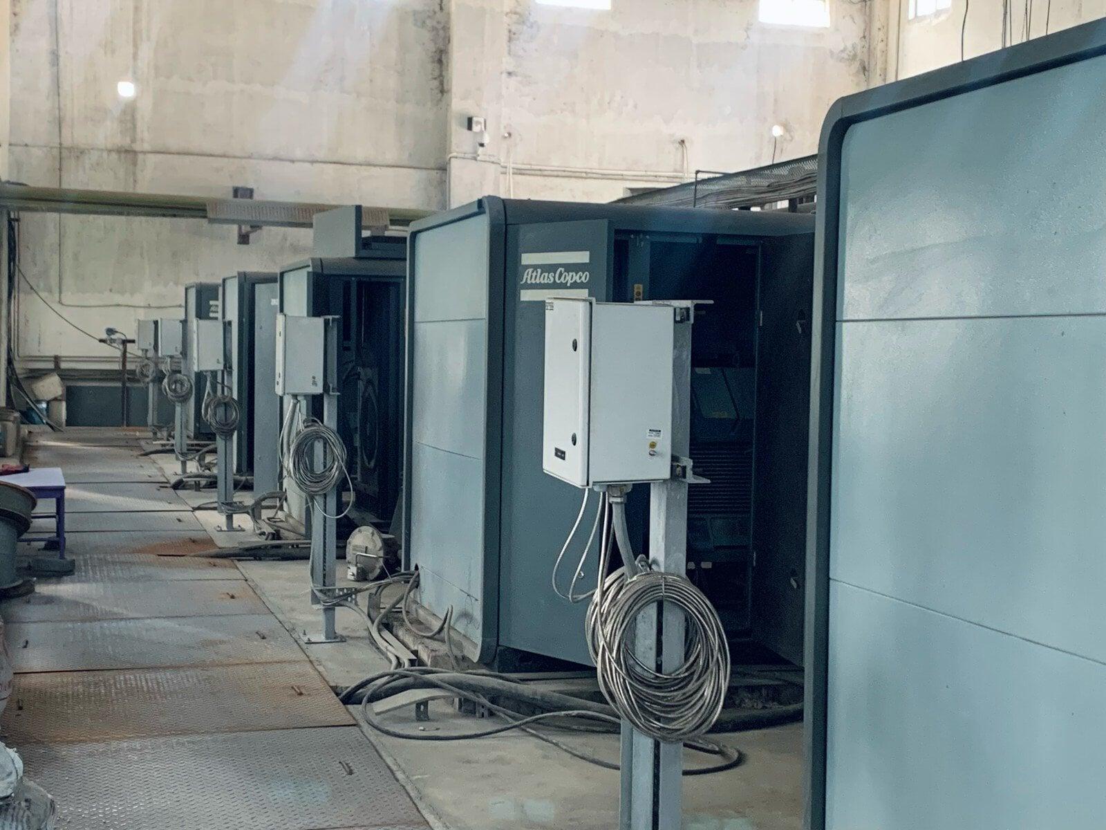 Row of Atlas Copco air compressor packages in a plant air house