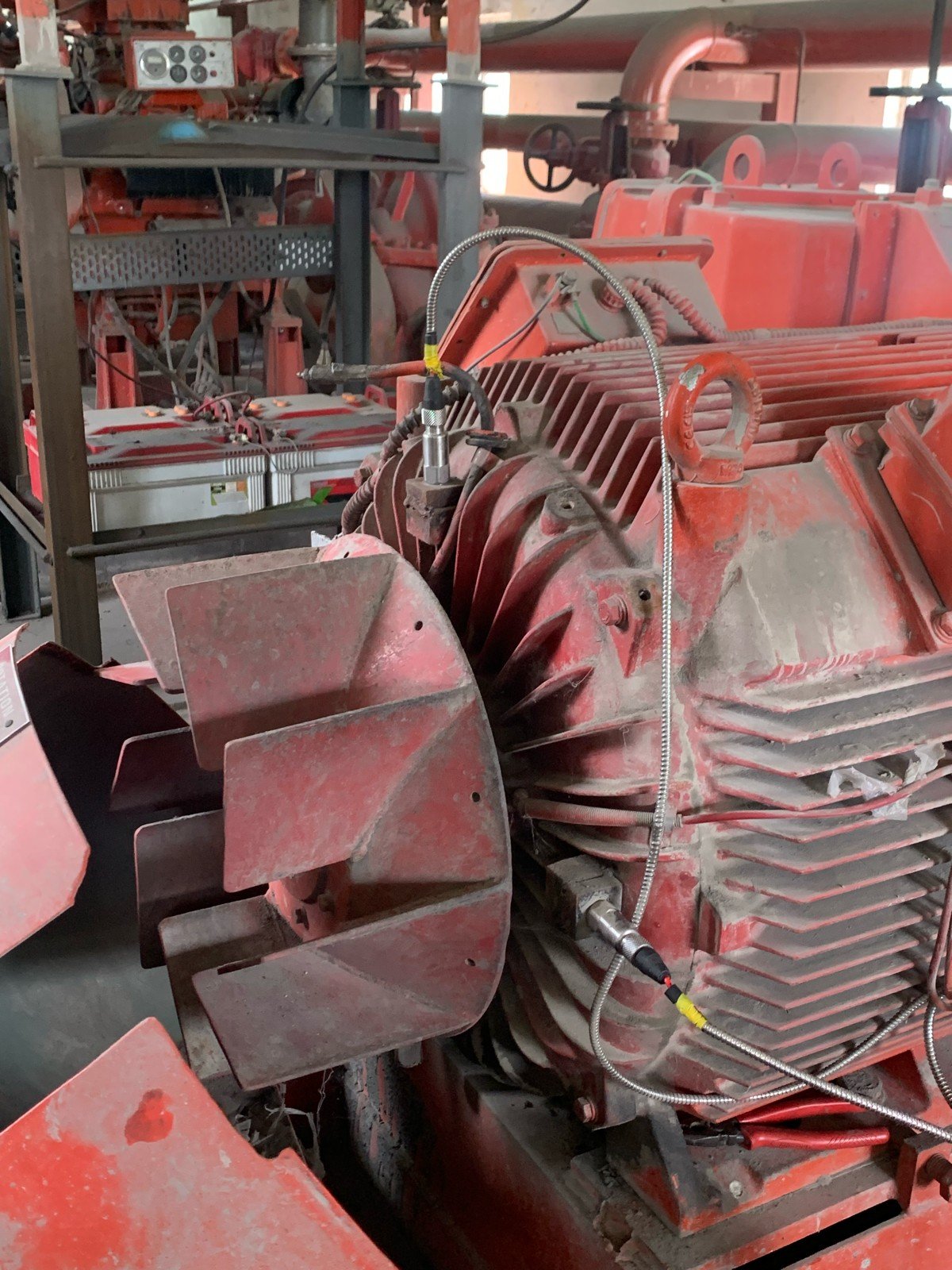 Red industrial motor with mounted vibration sensors